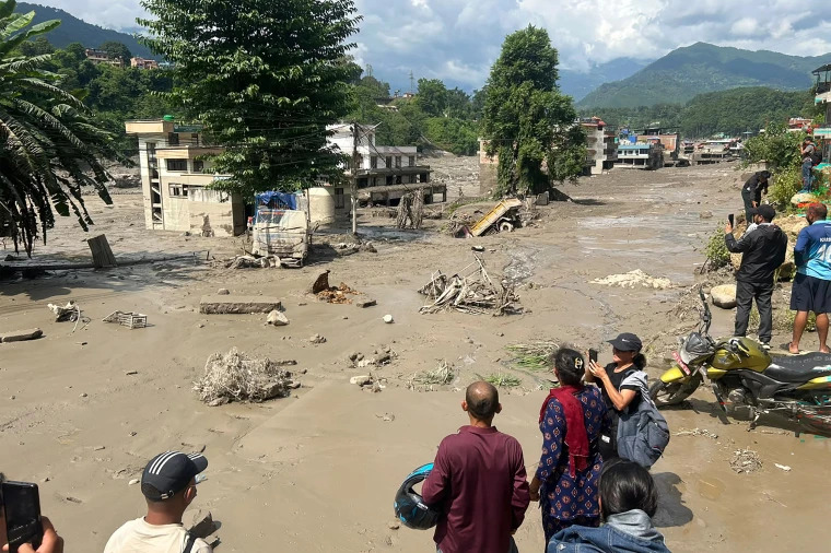 Rescue teams search through mud and debris after devastating floods and landslides in Nepal.